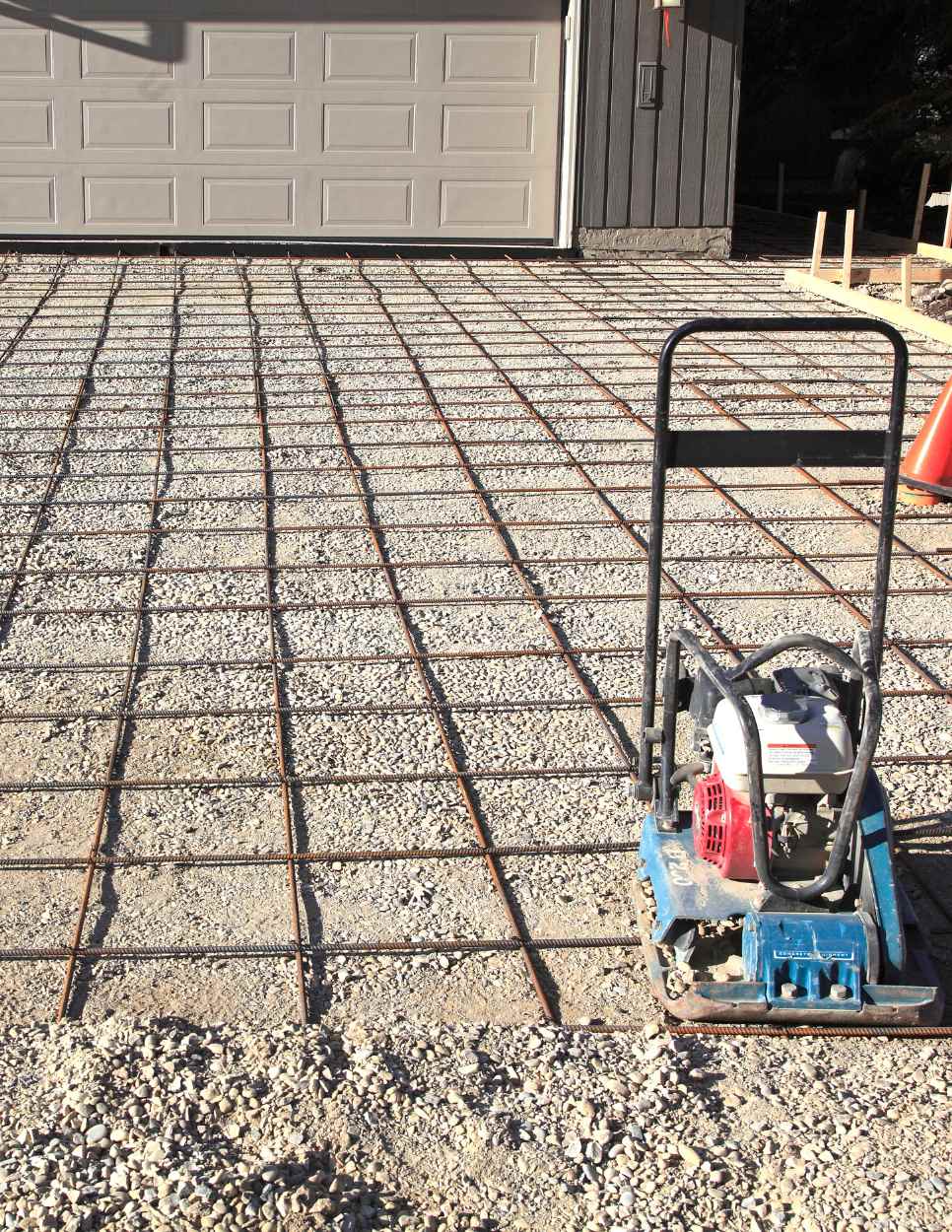 gravel driveway and leveler to prep for new concrete pour